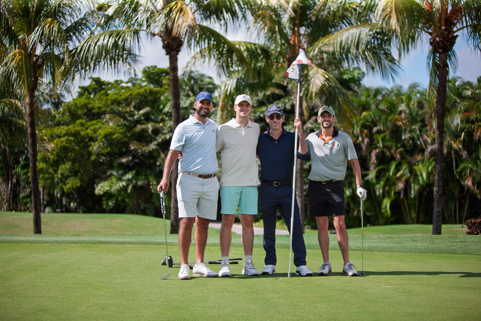 Foursome on palm-lined green